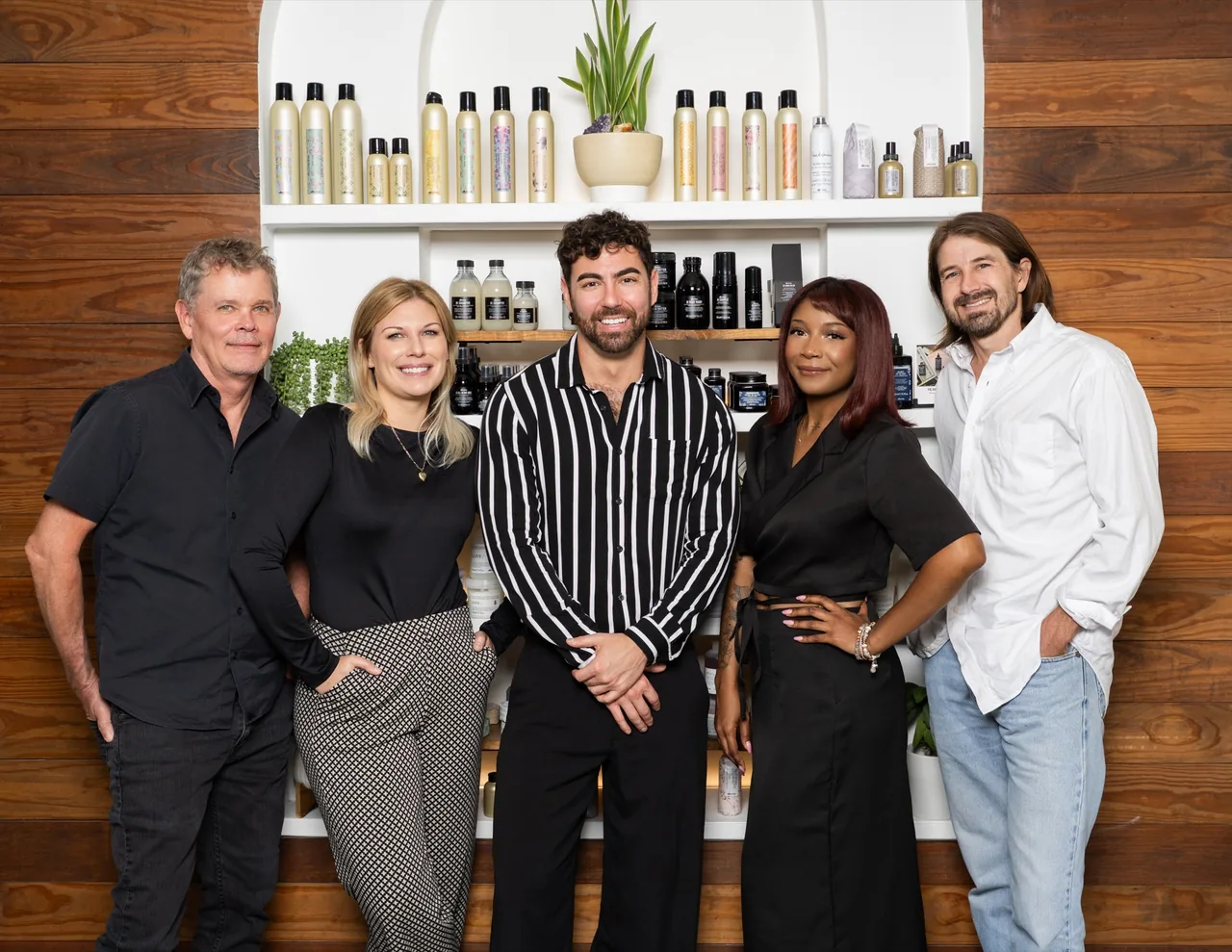 The Jeremie Kendal Salon team in front of the salon’s arched retail wall.